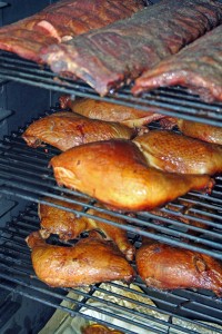 Ribs and chicken being smoked in wild cherry wood