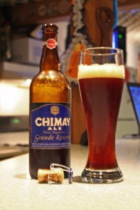 Chimay Ale uncorked and filling a Pilsner glass