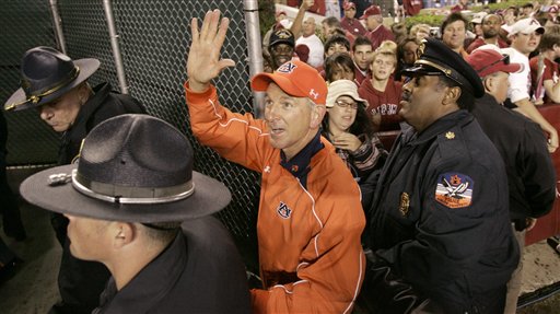 Tommy Tuberville of Auburn holds up five fingers after 5th straight win over Alabama